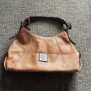 Dooney & Bourke tan with red lining pebble leather bag.